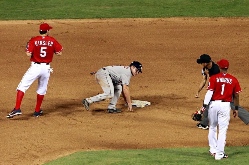 Second base umpire Vic Carapazza (far right) signals Houston Astros designated hitter Max...