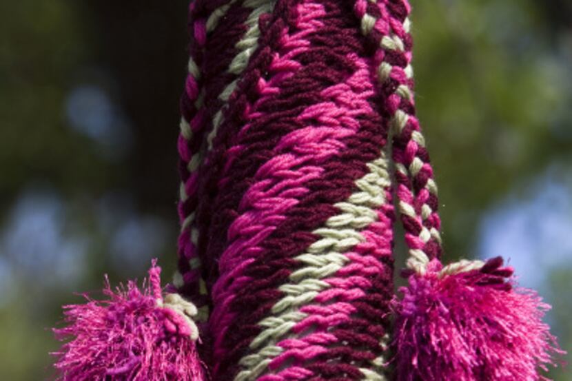 Yarn bombers use leftover or sturdy acrylic yarn for their craft. This pole near the...
