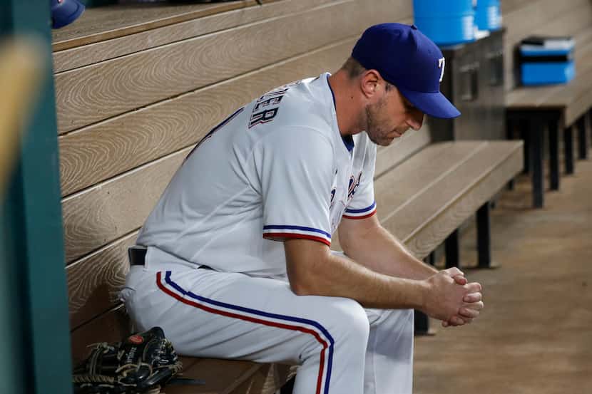 Texas Rangers starting pitcher Max Scherzer (31) sits in the dugout before  a baseball game...