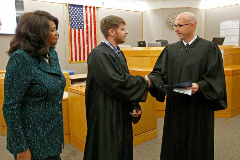 Judge Brandon Birmingham (right) shakes hands with Charles Troutman (center) as Dallas...