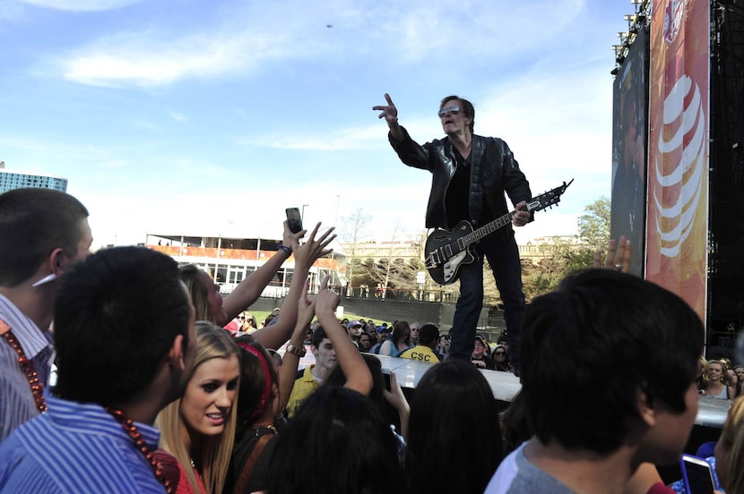 Jack Ingram throws a pick to the crowd at the 2014 NCAA March Madness Music Festival during...