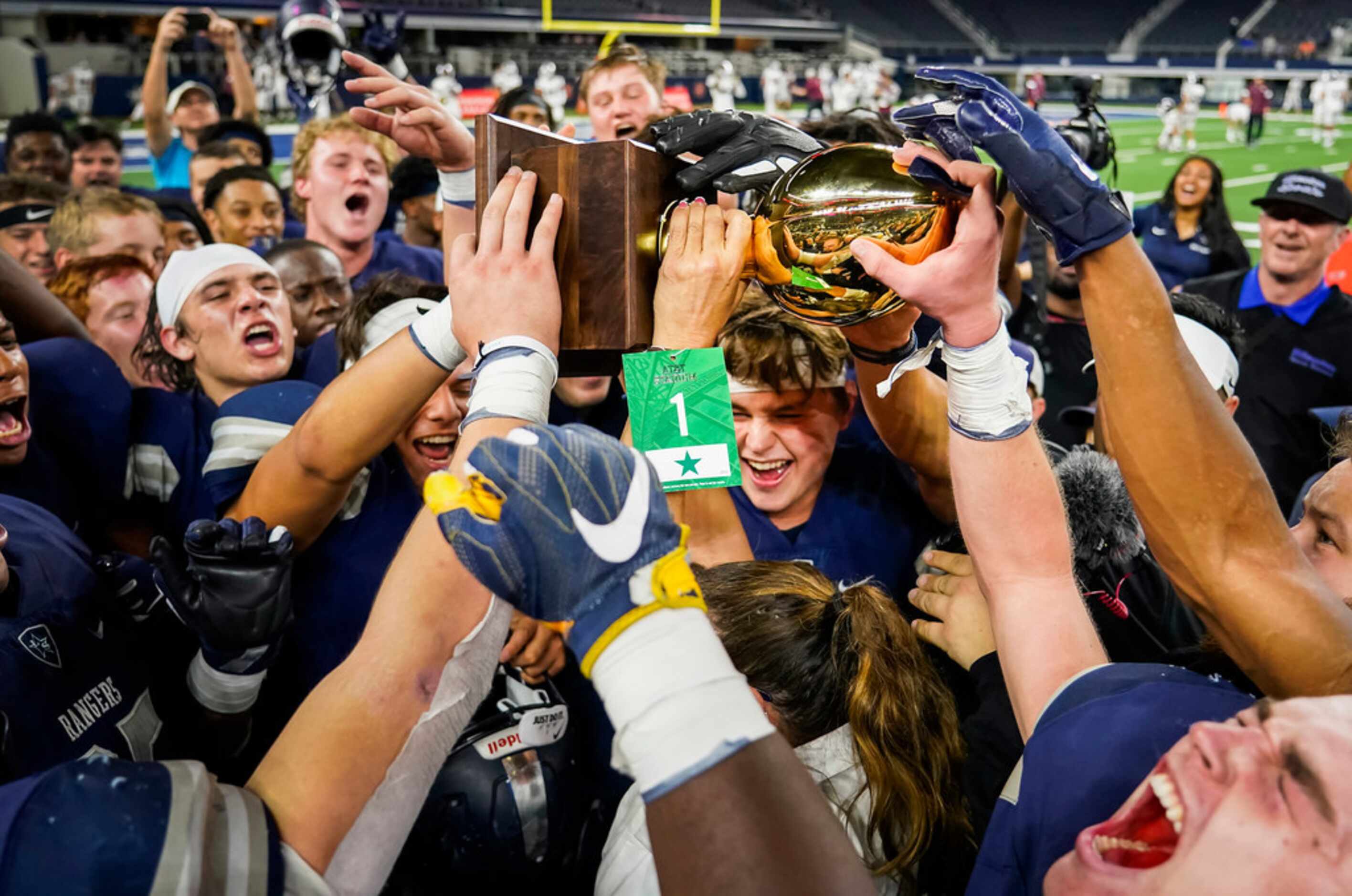 Frisco Lone Star Head celebrate with the game trophy after the Rangers a 33-27 overtime...
