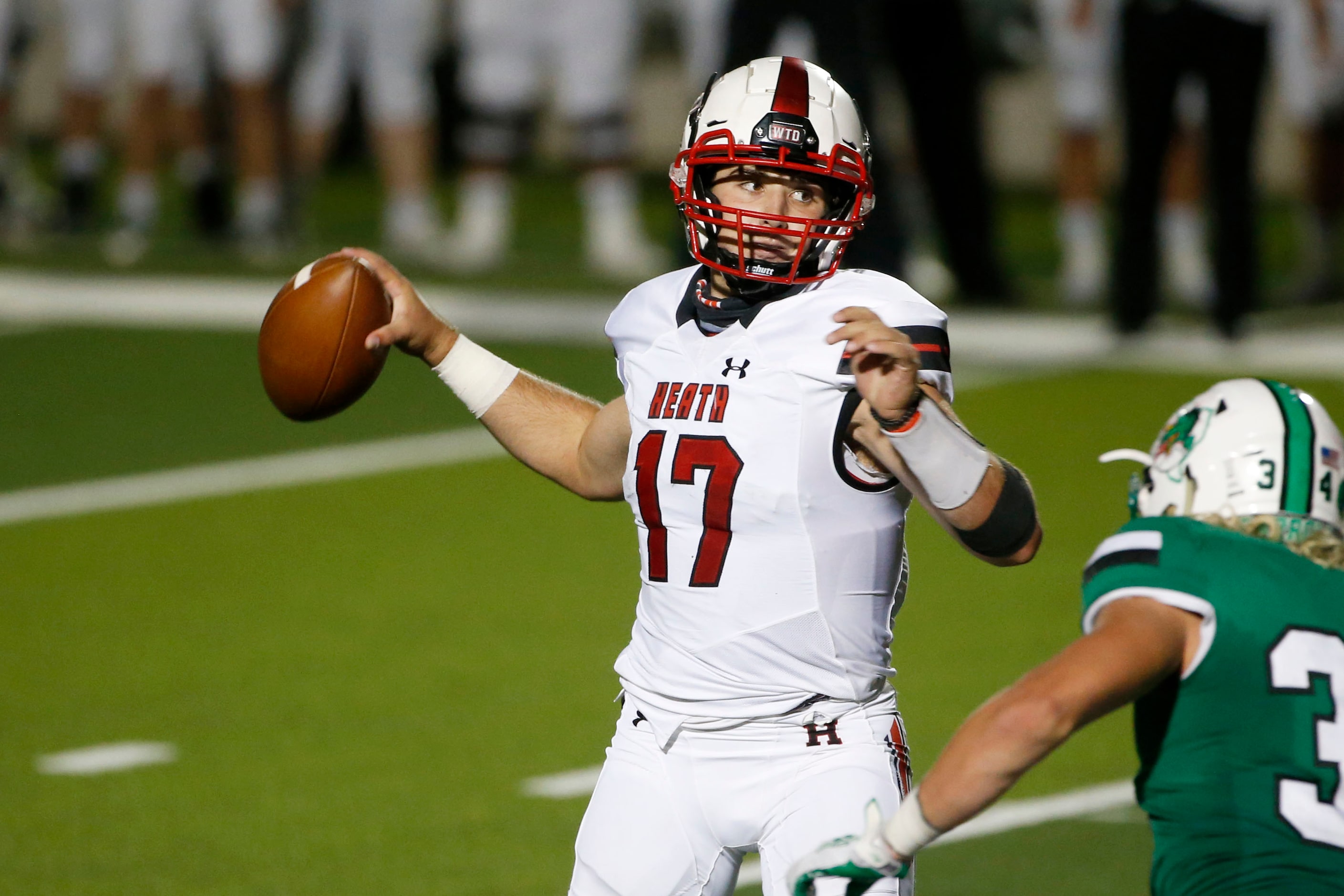 Rockwall Heath quarterback Josh Hoover (17) looks to throw against Southlake Carroll during...