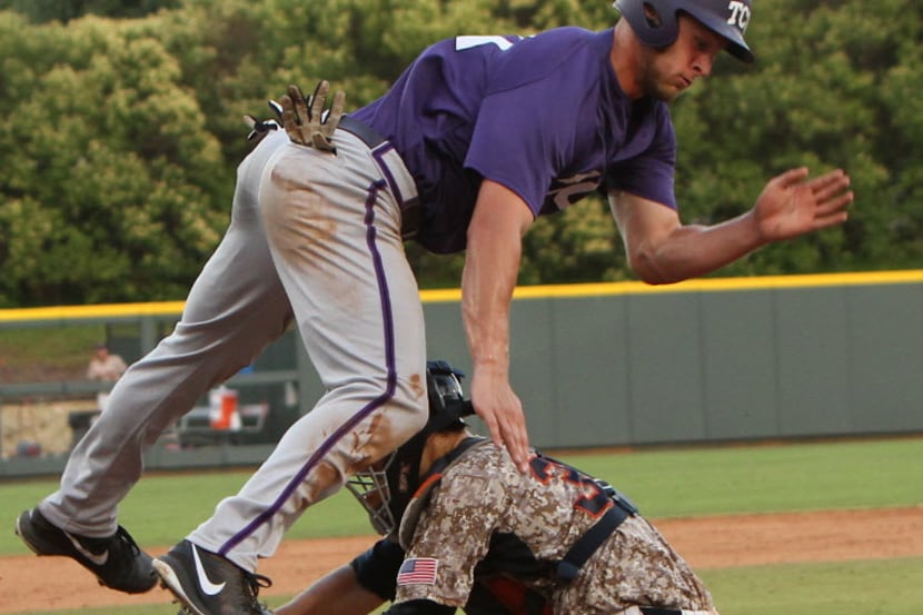TCU designated hitter Jerrick Suiter (31) attempts to leap over the tag by Pepperdine...