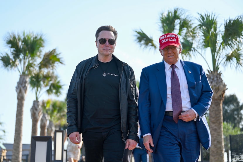 President-elect Donald Trump walks with Elon Musk before the launch of the sixth test flight...