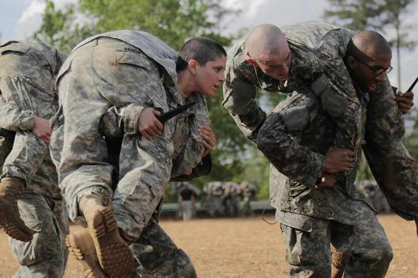 
In a handout photo provided by the U.S. Army, Capt. Kristen Griest, center, participates in...