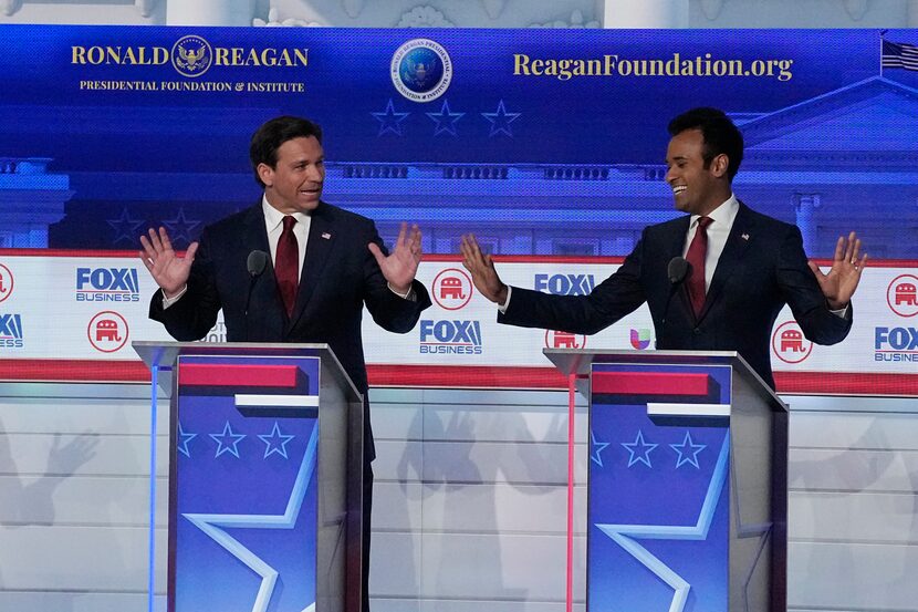 Florida Gov. Ron DeSantis, left, argues with businessman Vivek Ramaswamy during a Republican...