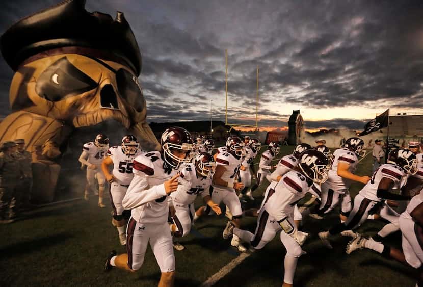 The Wylie players take the field before the Wylie High School Pirates vs. the Garland Naaman...