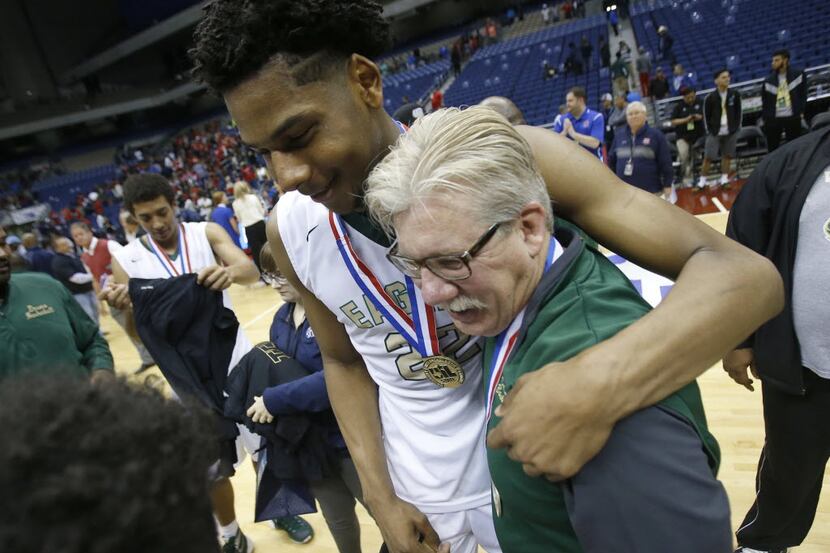 DeSoto's Marques Bolden hugs head coach Chris Dyer as they celebrate a 73-54 win over Humble...