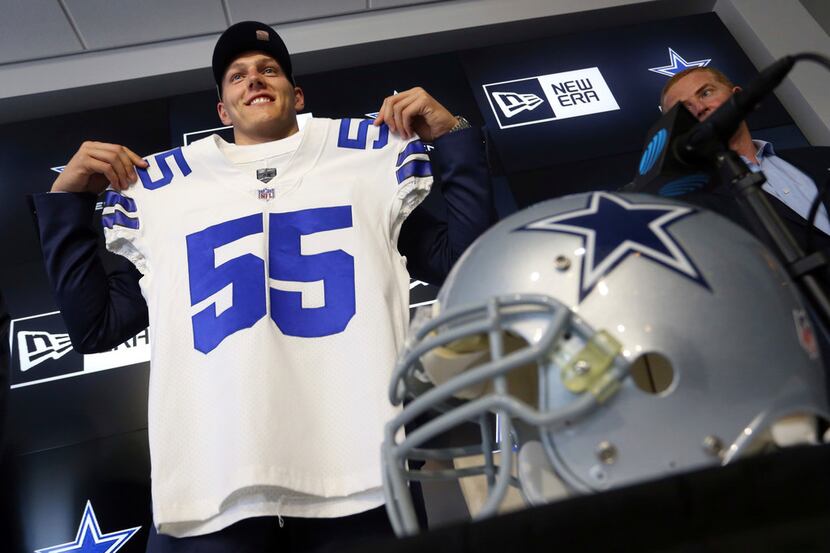 Dallas Cowboys first round draft pick Leighton Vander Esch holds up a jersey at the end of...
