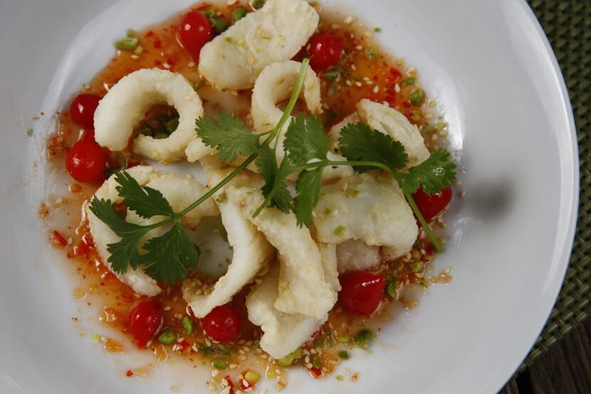 Calamari slices come on a pool of sweet chile sauce with tiny sweety drop peppers.