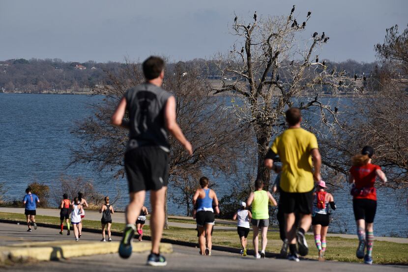 Runners alongside White Rock Lake during this year's BMW Dallas Marathon, Sunday Dec. 15,...