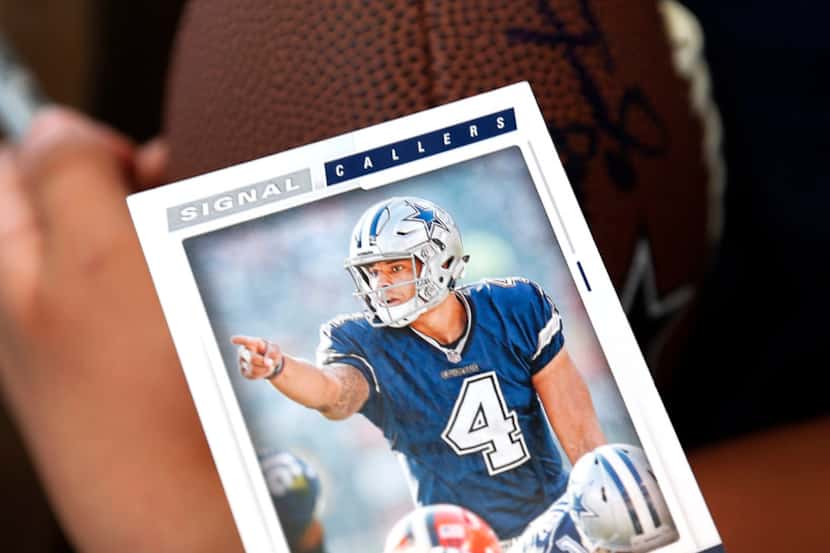 A Dallas Cowboys fan holds a Dak Prescott sports card during the 2018 NFL Draft at AT&T...