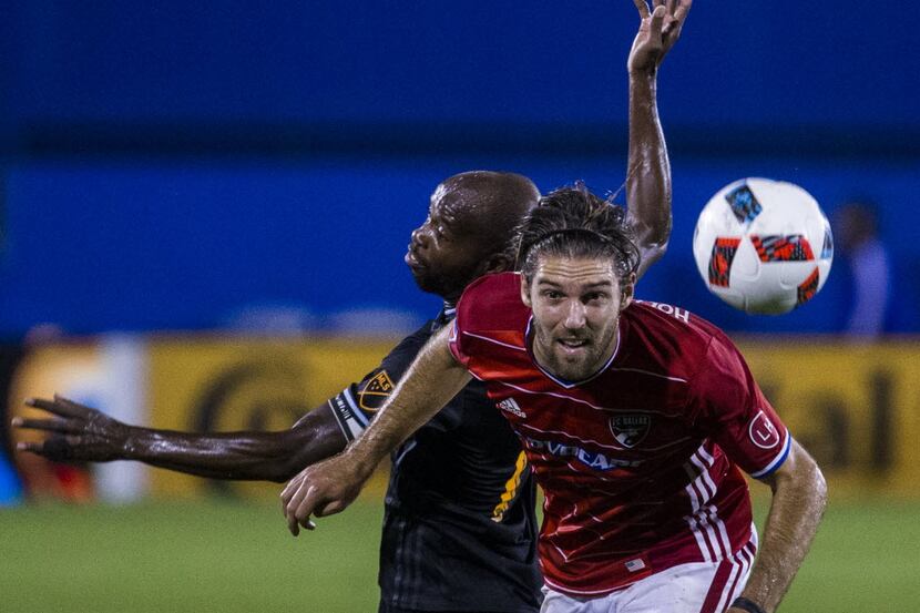 FC Dallas midfielder Ryan Hollingshead (12) watches as the ball gets away from him and...