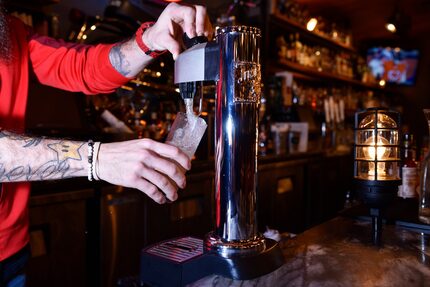 Bar manager Kris Johnson, left, pours a Japanese Highball from a Jim Beam Black Highball...