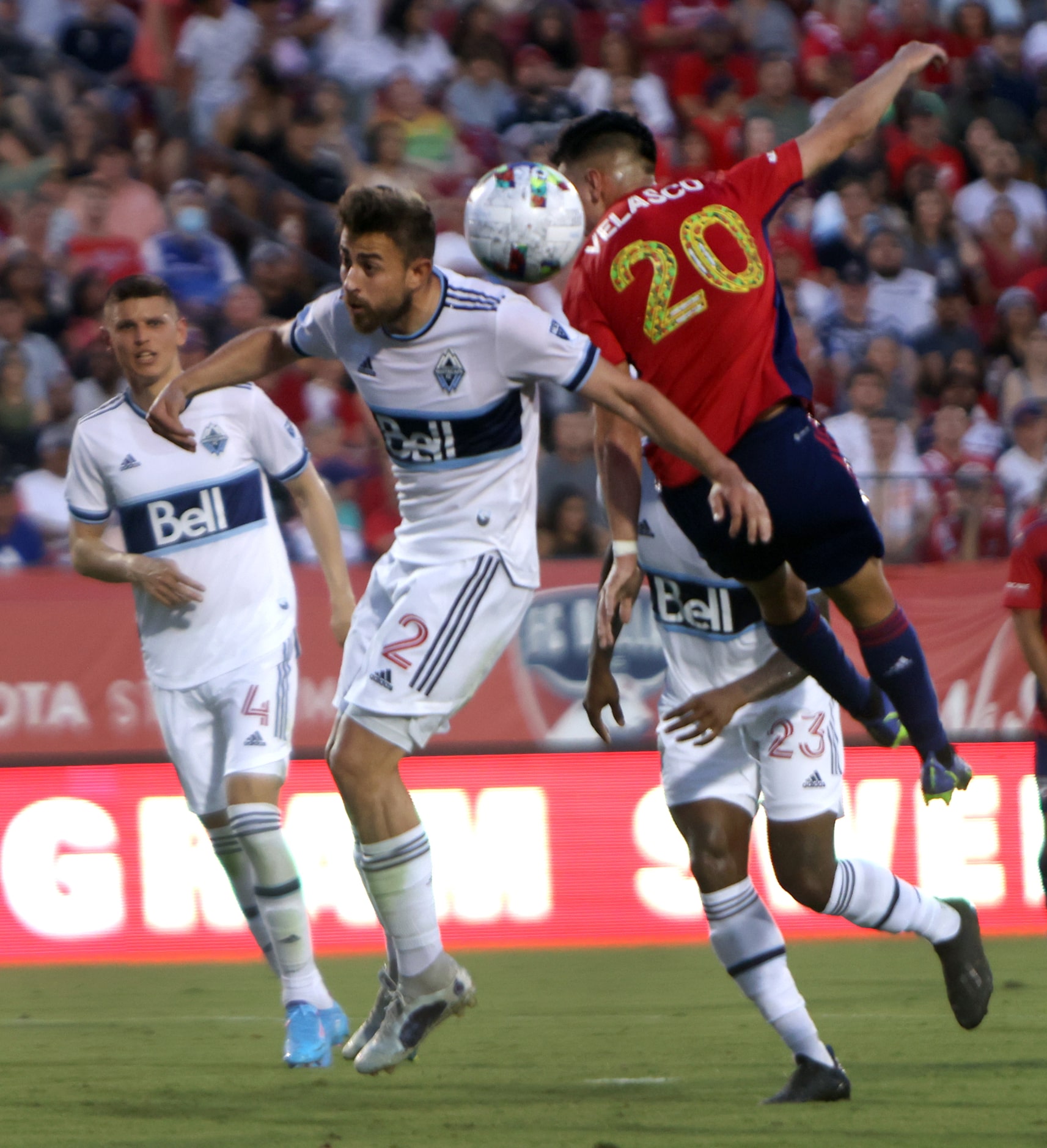 FC Dallas forward Alan Velasco (20) attempts to head the ball toward the goal as he is...