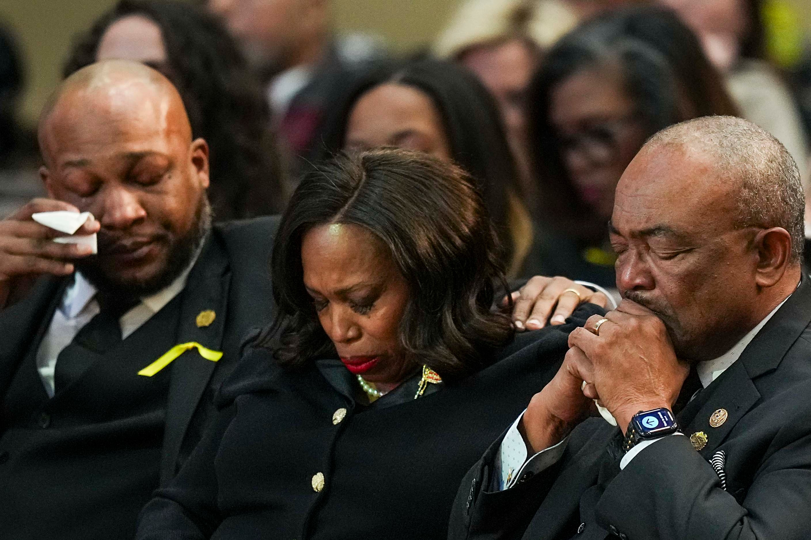 Dawrence Kirk Johnson, II, grandson of  former U.S. Rep. Eddie Bernice Johnson, wipes a tear...