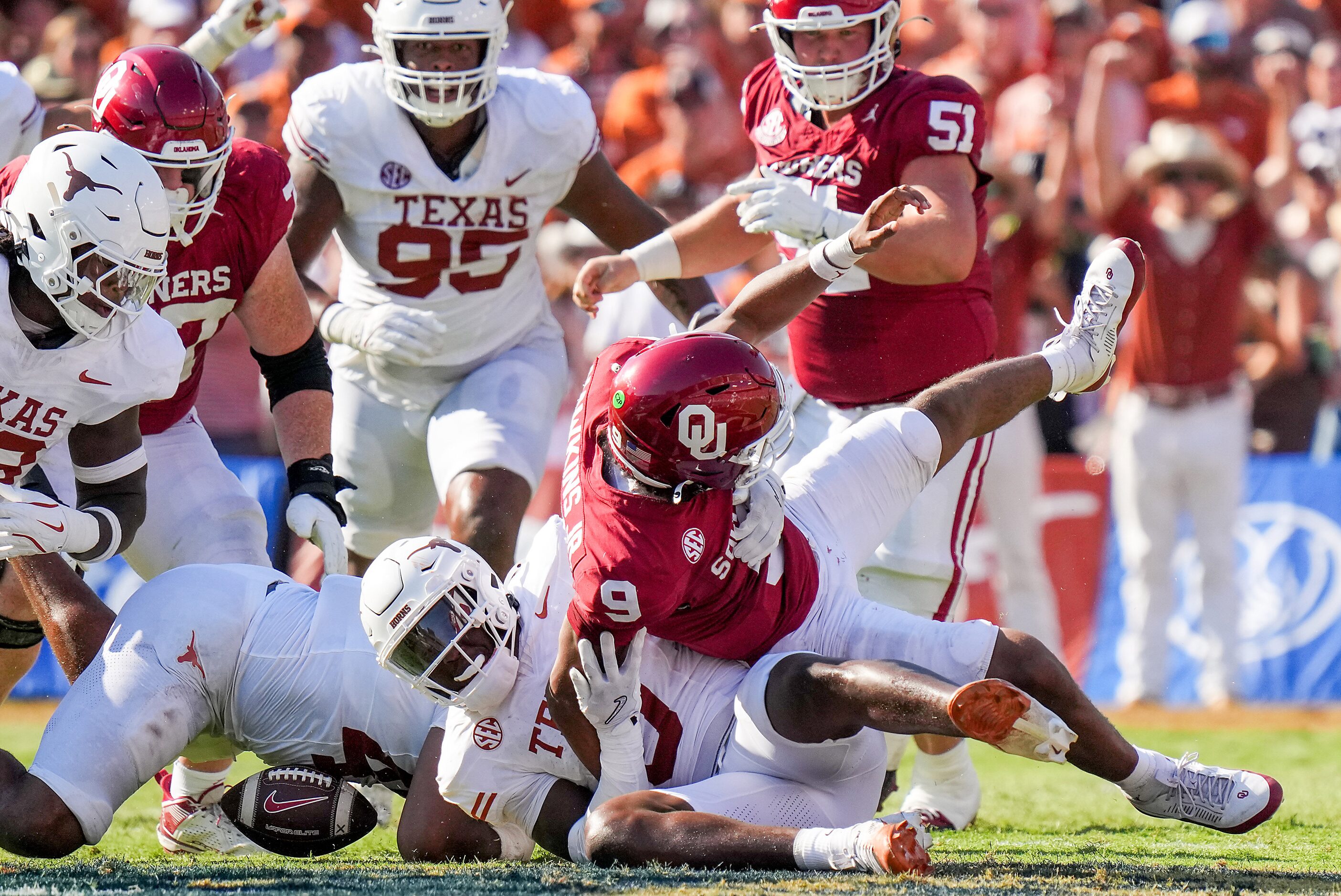 Oklahoma quarterback Michael Hawkins Jr. (9) fumbles as he is brought down by Texas...