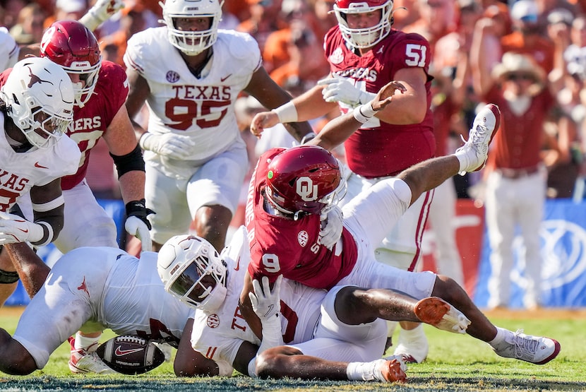 Oklahoma quarterback Michael Hawkins Jr. (9) fumbles as he is brought down by Texas...