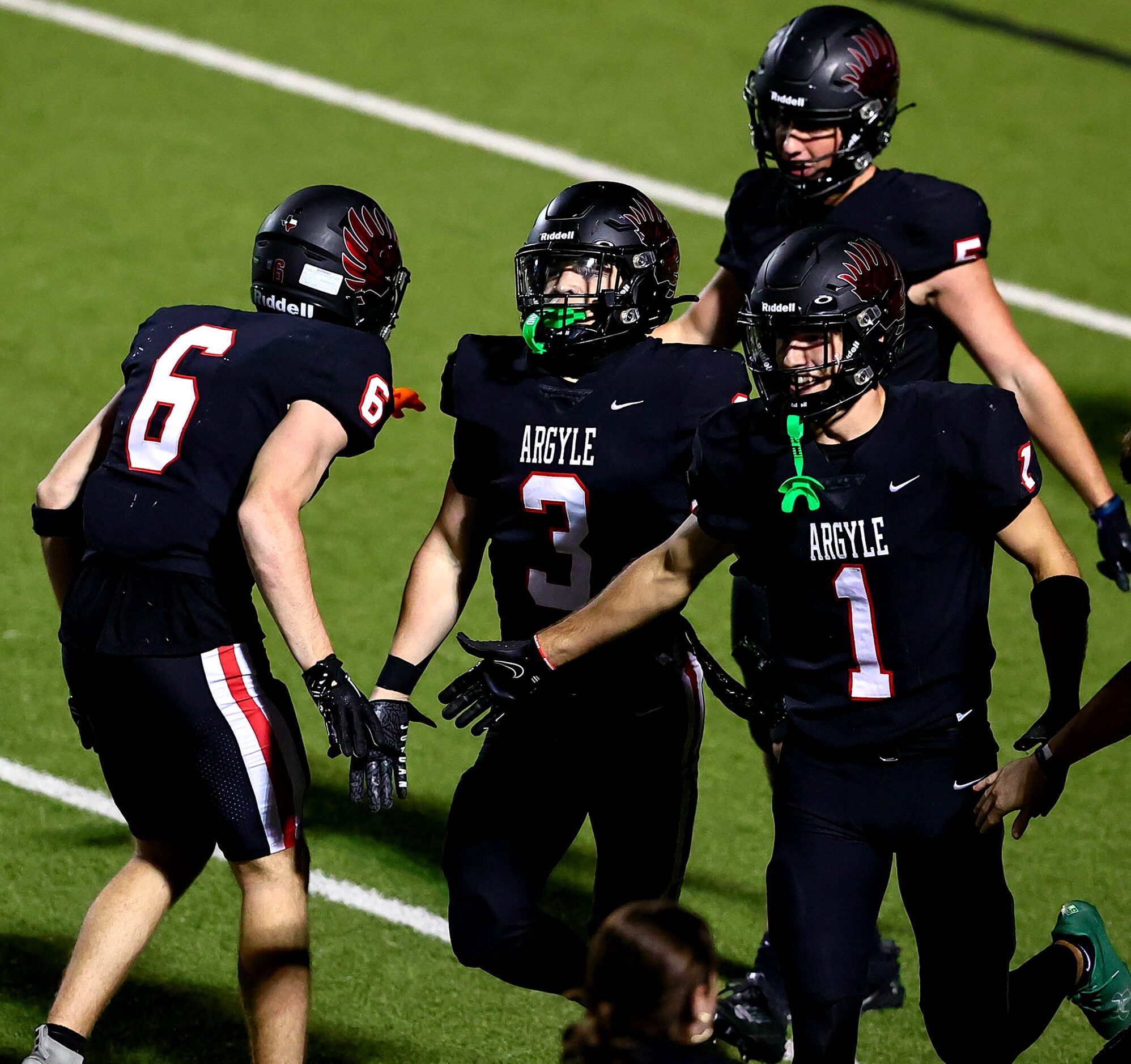 Argyle running back Jake Krekeler (3) celeabrates with his teammates after scoring the...