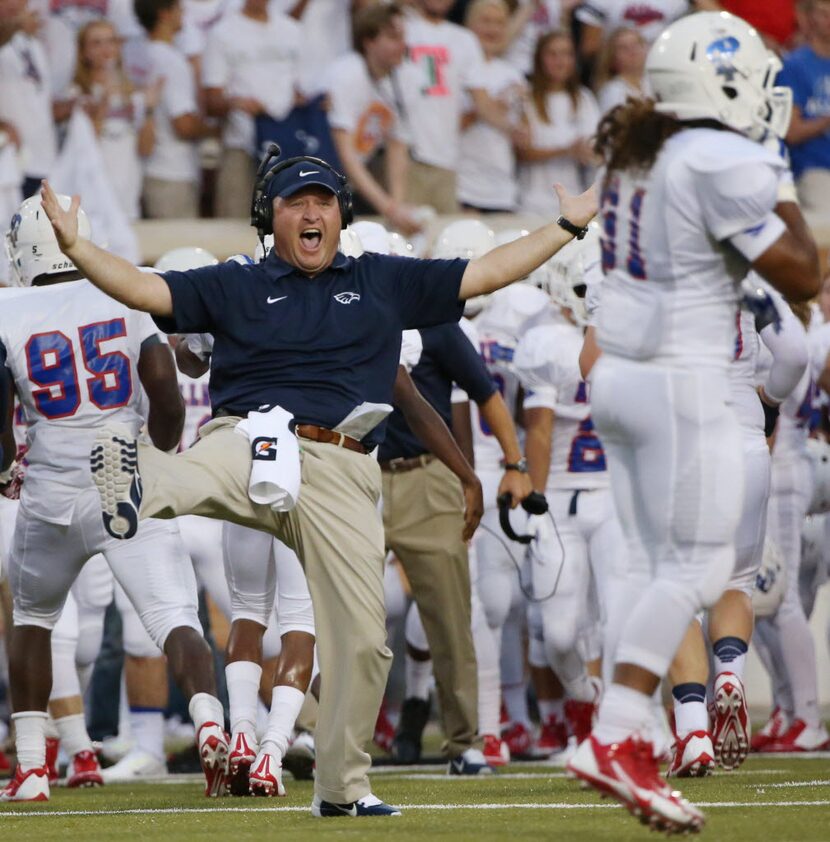 Allen defensive coordinator Cory Cain reacts to a fumble recovery in favor of Allen during a...