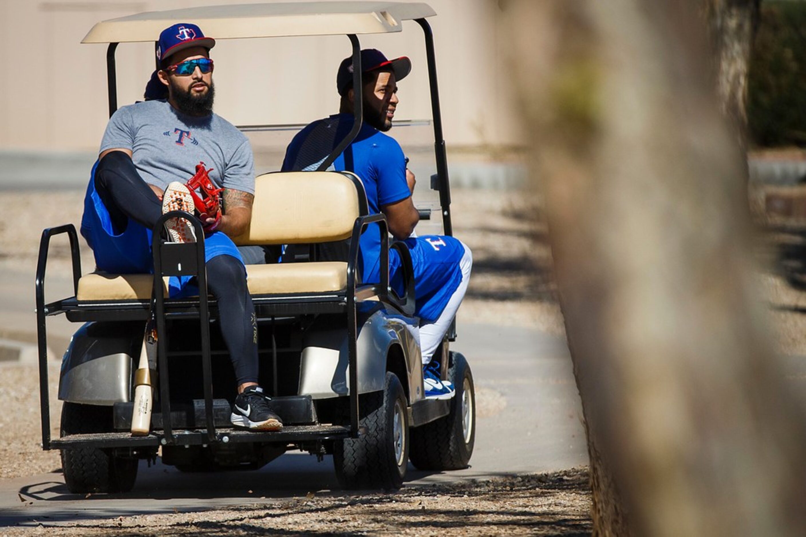 Texas Rangers second baseman Rougned Odor (left) and shortstop Elvis Andrus ride a cart back...