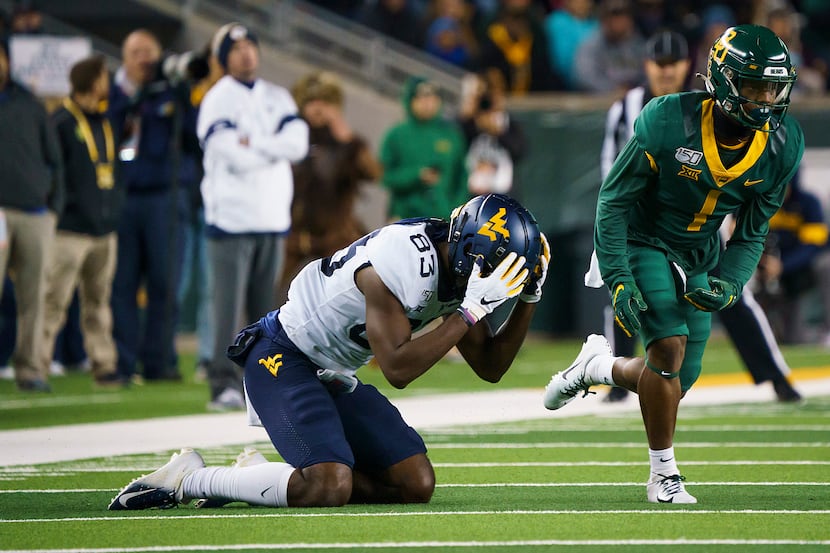 West Virginia wide receiver Bryce Wheaton (83) reacts after missing a pass with Baylor...