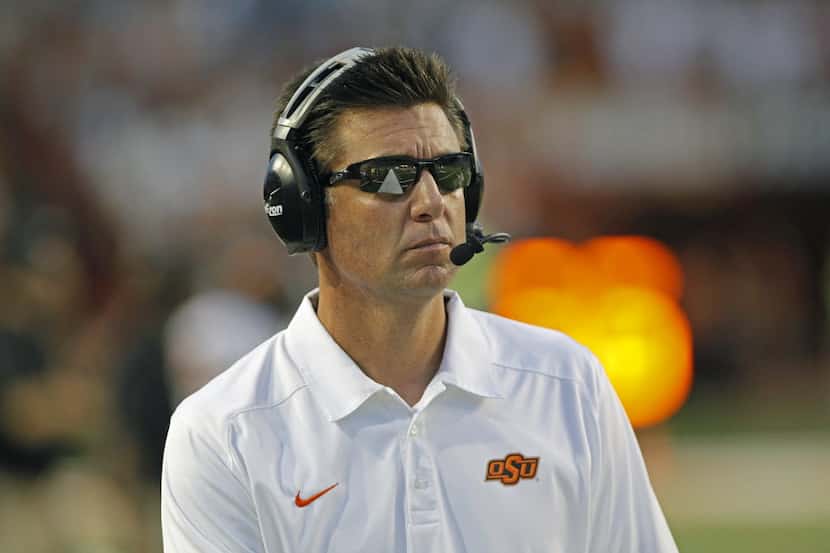 Oklahoma State coach Mike Gundy watches his team during the fourth quarter against Texas in...