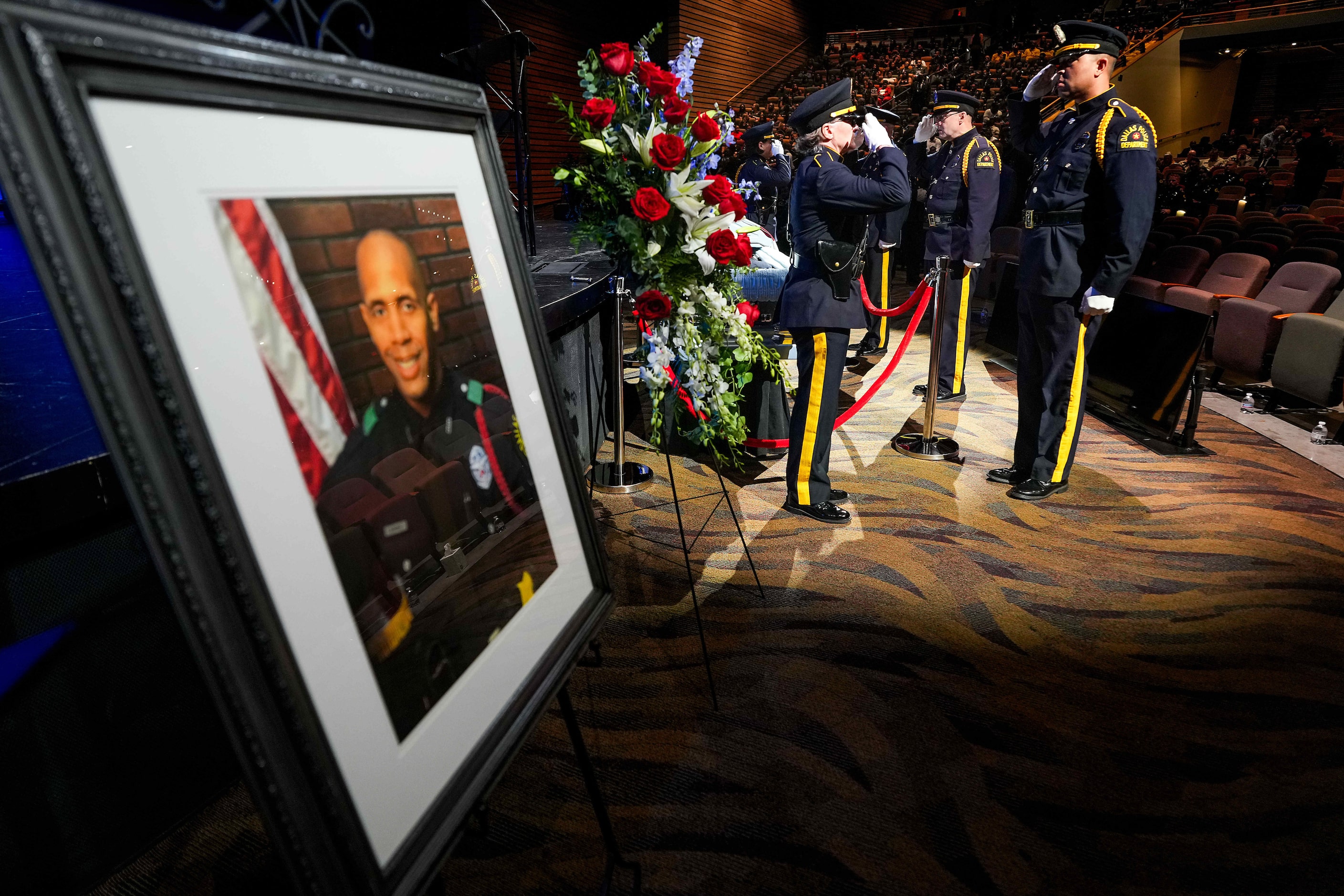 Members of the Dallas Police Honor Guard  salute at the casket of officer Darron Burks...