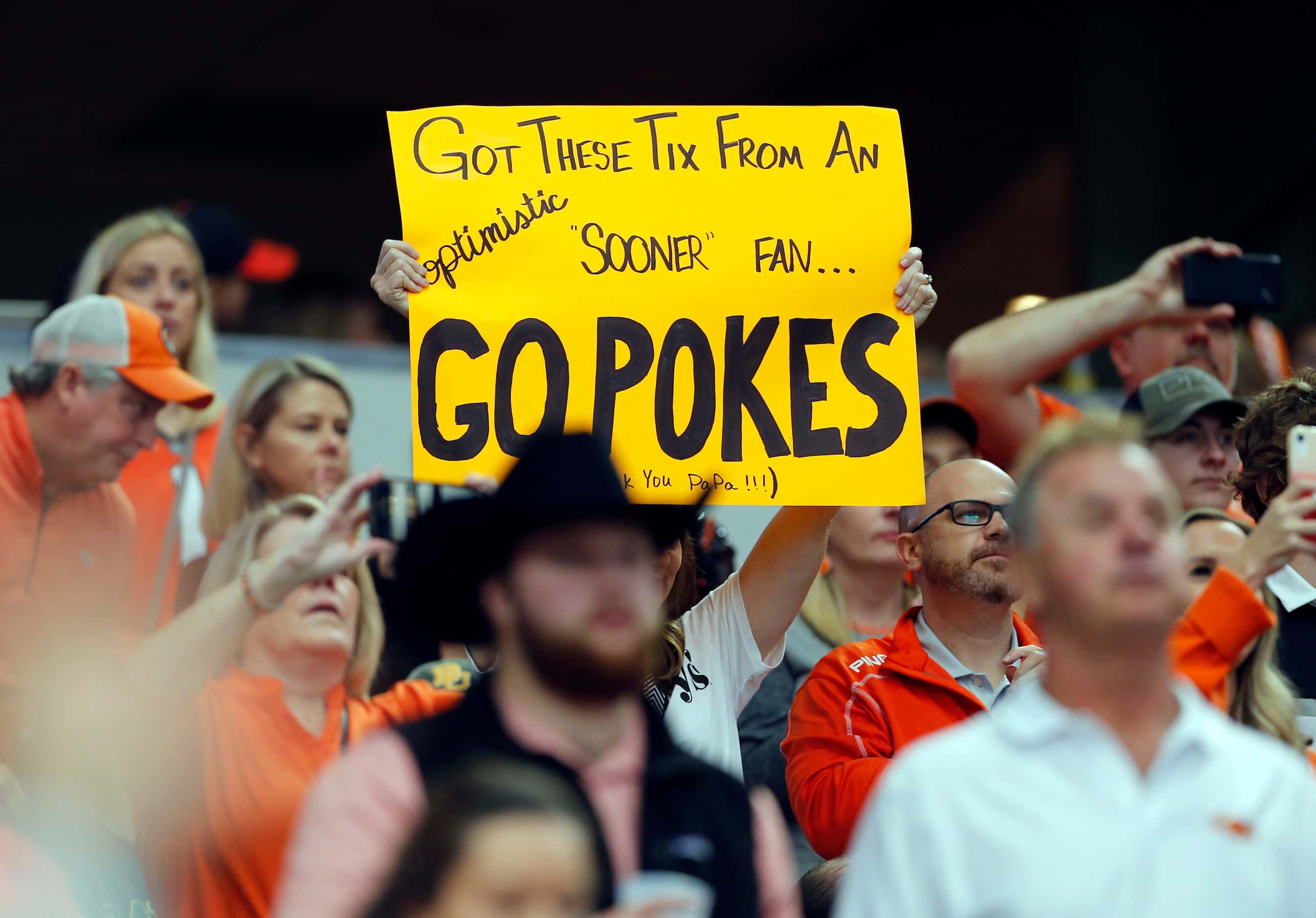 An Oklahoma State fans holds up her sigh before the start of the first half of the Big 12...
