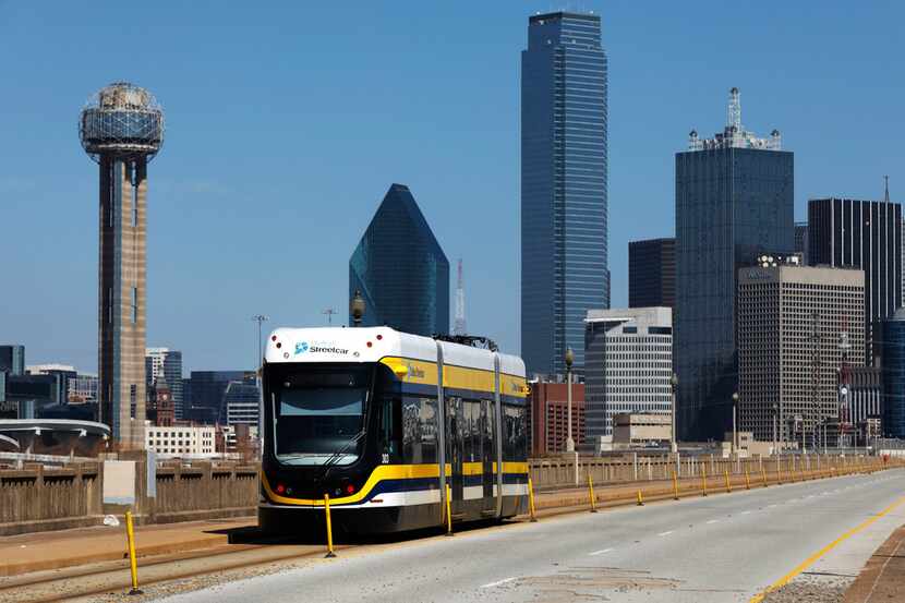 The Dallas Streetcar makes its way across the Houston Street viaduct to Oak Cliff out of...