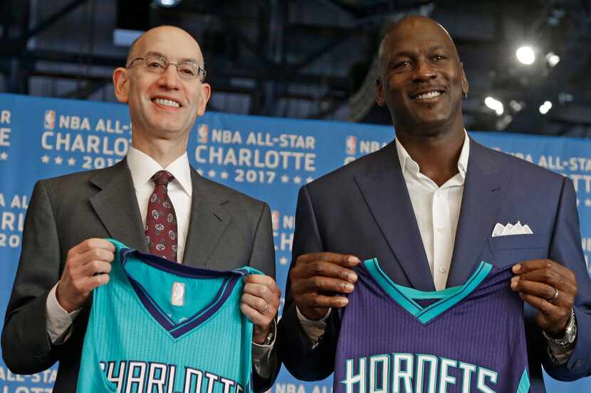 FILE - NBA commissioner Adam Silver, left, and Charlotte Hornets owner Michael Jordan pose...