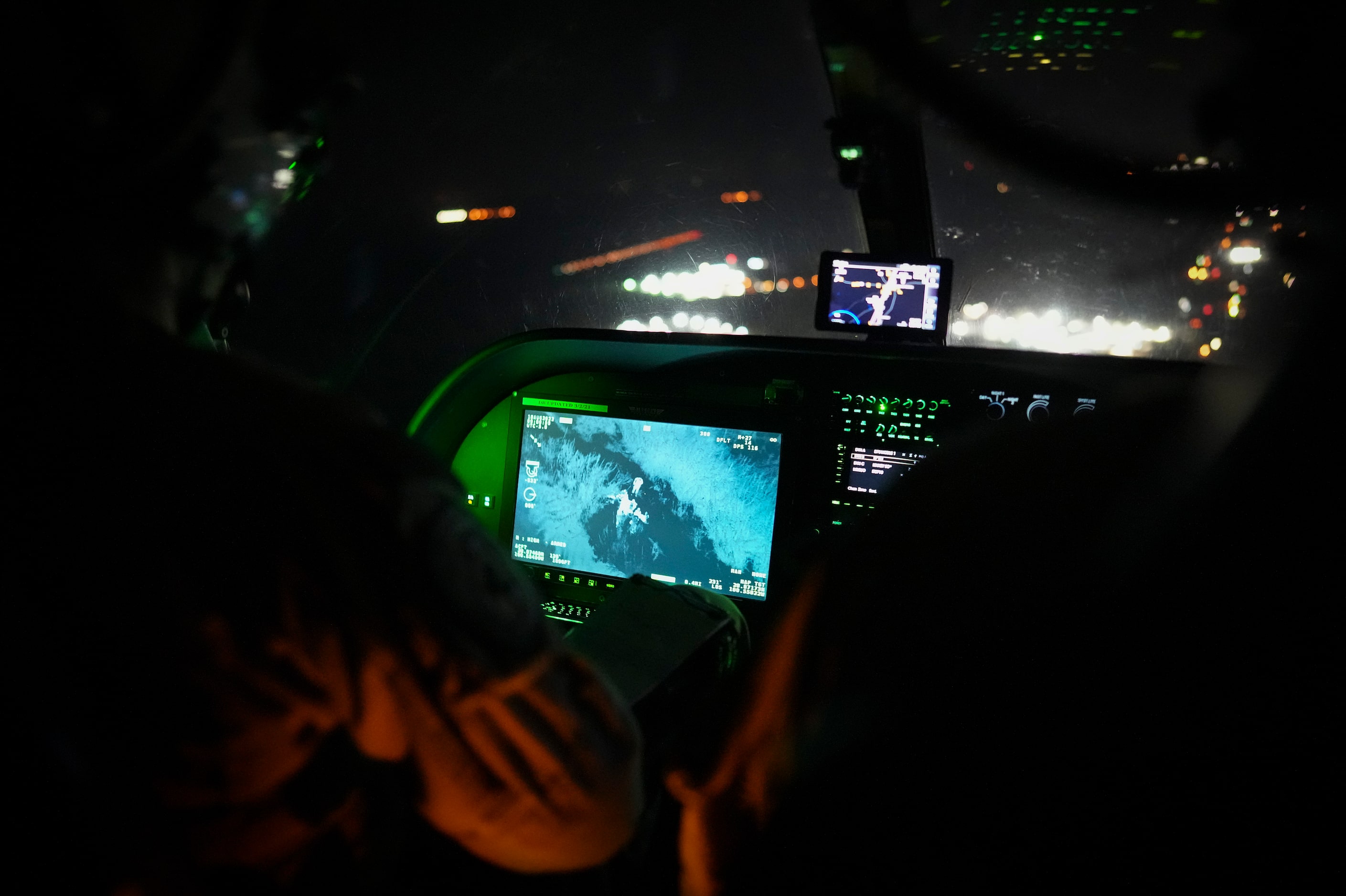 Texas Department of Public Safety tactical flight officer Jaclyn Gooding tracks the movement...