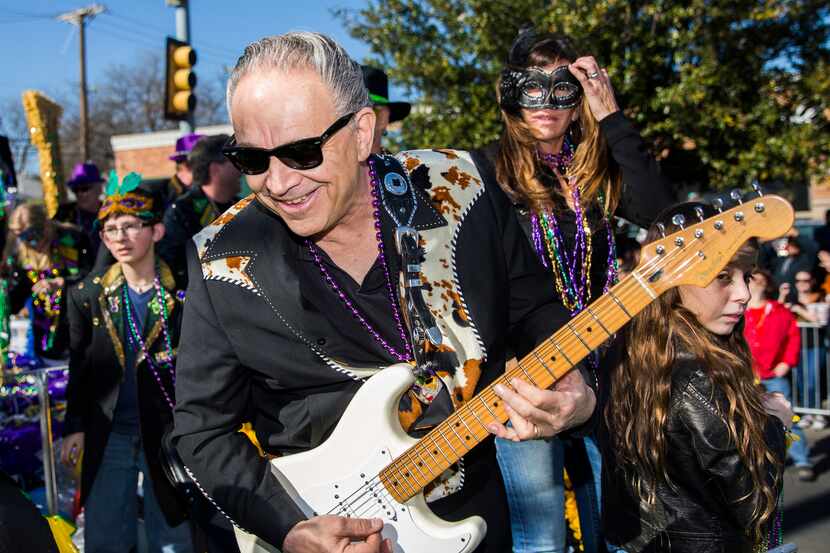 Jimmie Vaughan played guitar on a float during the annual Oak Cliff Mardi Gras parade in...