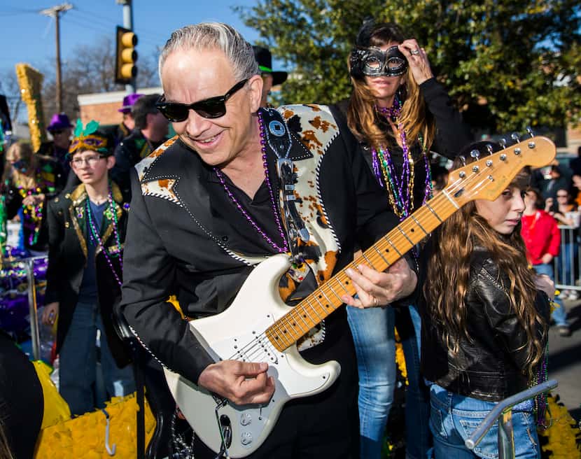Musician and parade grand marshal Jimmie Vaughan played his guitar on a float during the...