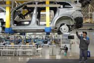 A worker assembles an SUV at a car plant of Li Auto, a major Chinese EV maker, in Changzhou...