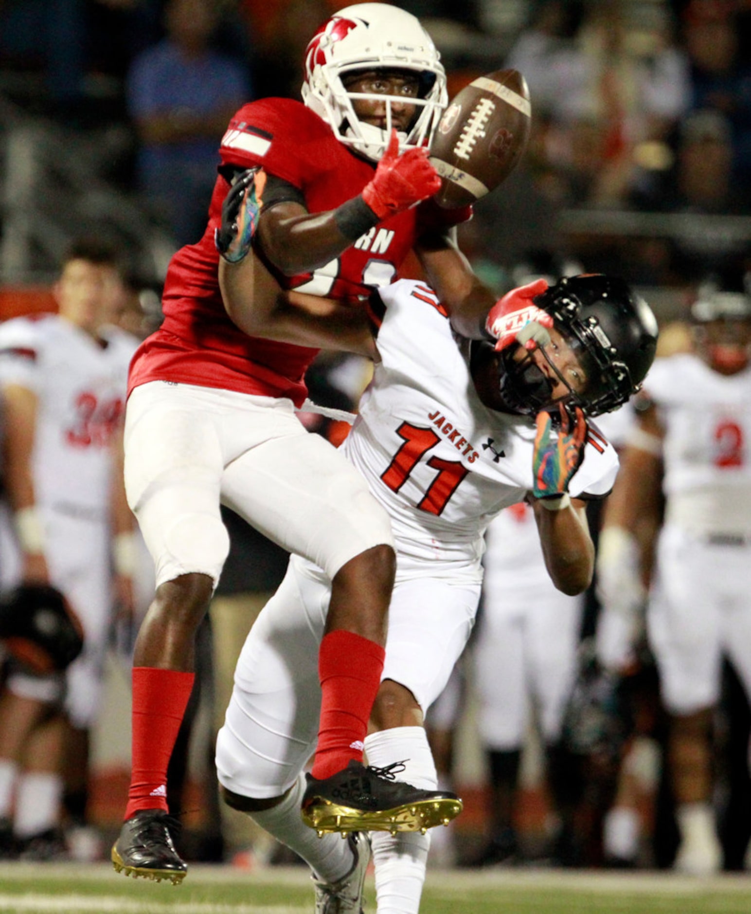 Mesquite Horn's Oric Walker (23) and Rockwall defender Jaxon Smith (11) battle for control...