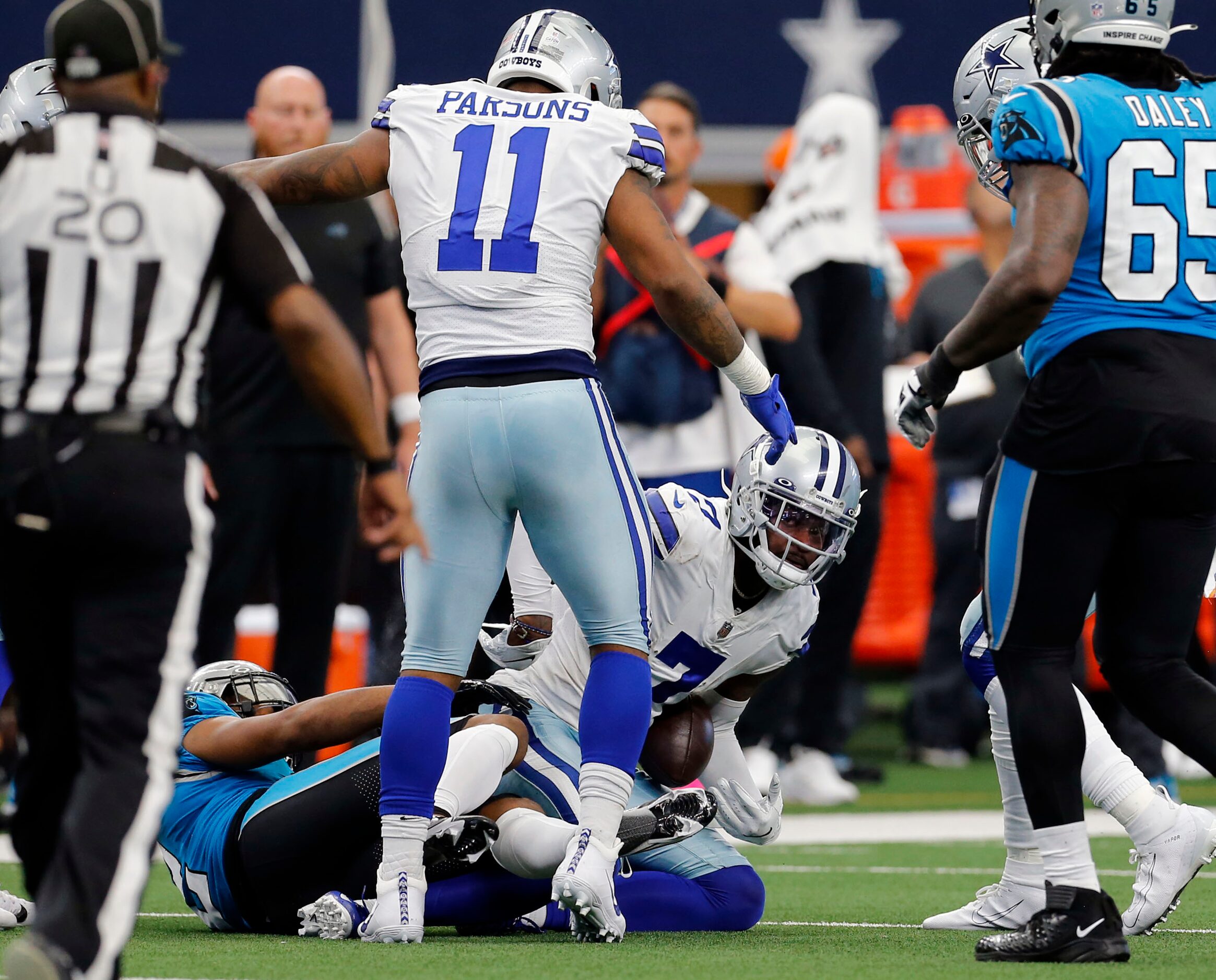 Dallas Cowboys cornerback Trevon Diggs (7) emerges from a pileup with the football for an...