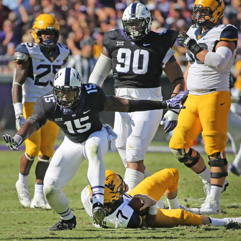 TCU defensive end Ben Banogu (15) celebrates sacking West Virginia quarterback Will Grier...