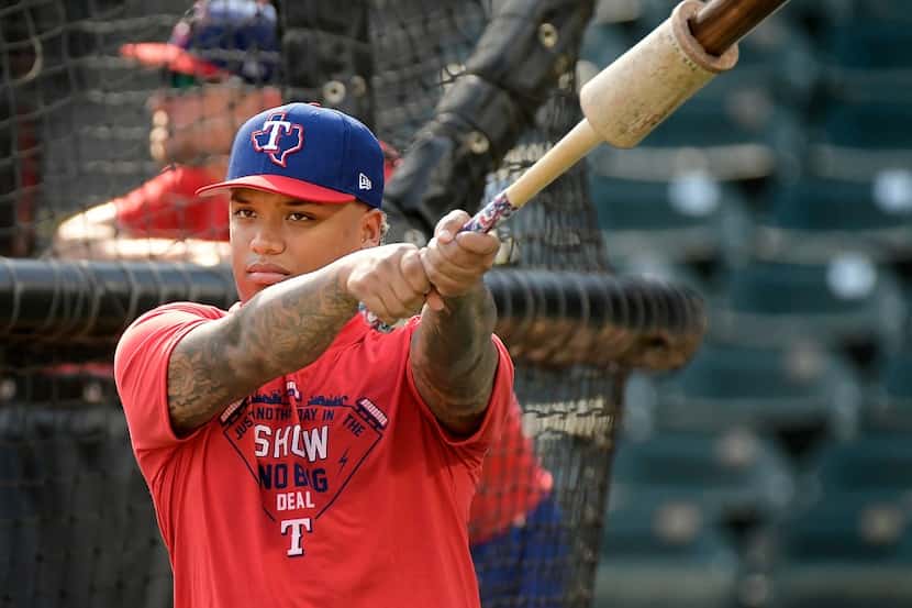 Texas Rangers rookie outfielder Willie Calhoun warming up for batting practice before a game...