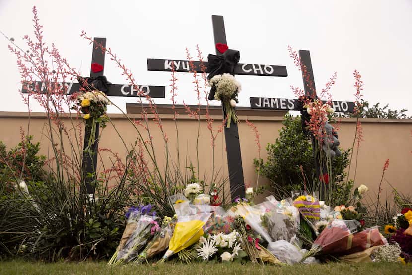 Crosses with the names of Cindy Cho, Kyu Cho and James Cho, who were victims of a mass...