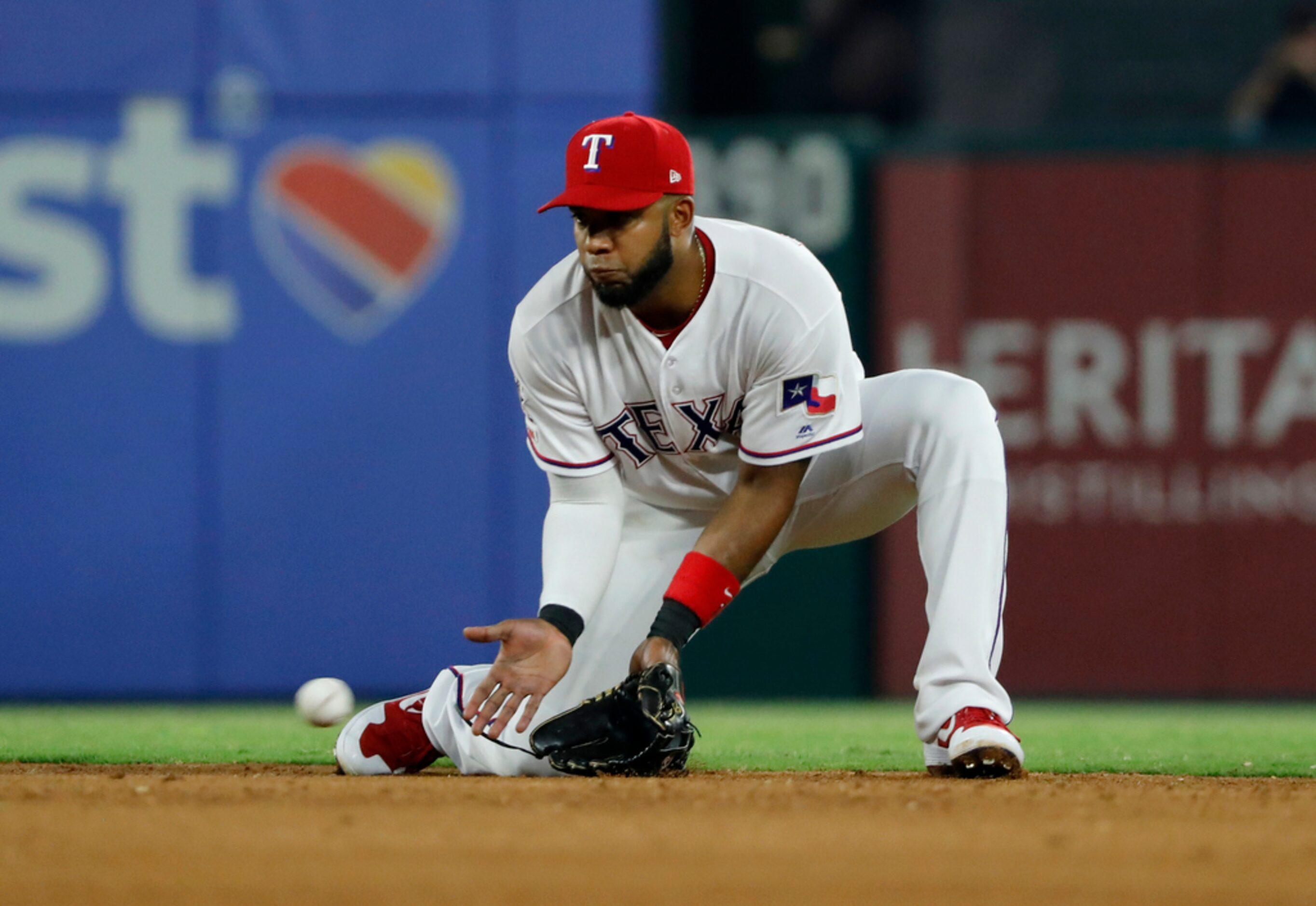 Texas Rangers shortstop Elvis Andrus fields a ground out by Detroit Tigers' Niko Goodrum...