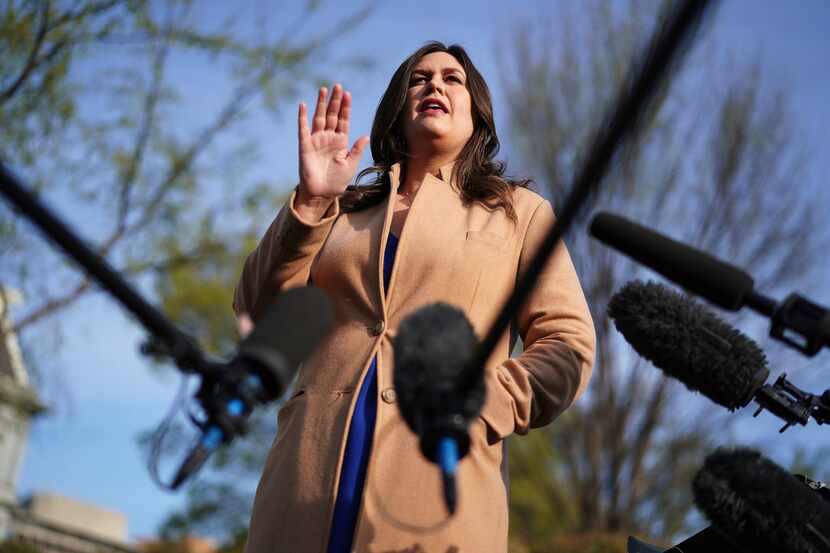 White House press secretary Sarah Huckabee Sanders talks to reporters outside the West Wing...