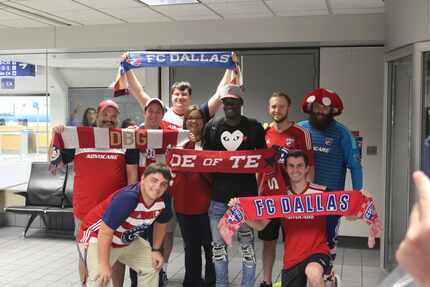 FC Dallas striker Dominique Badji poses with fans who traveled to DFW to greet the team's...