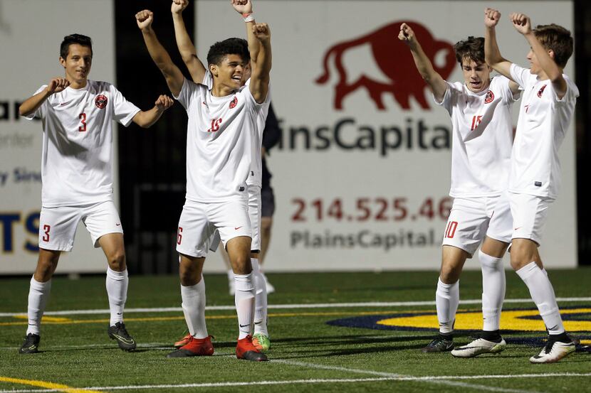 Coppell junior forward Francisco Redondo (16) celebrates with teammates after scoring a goal...