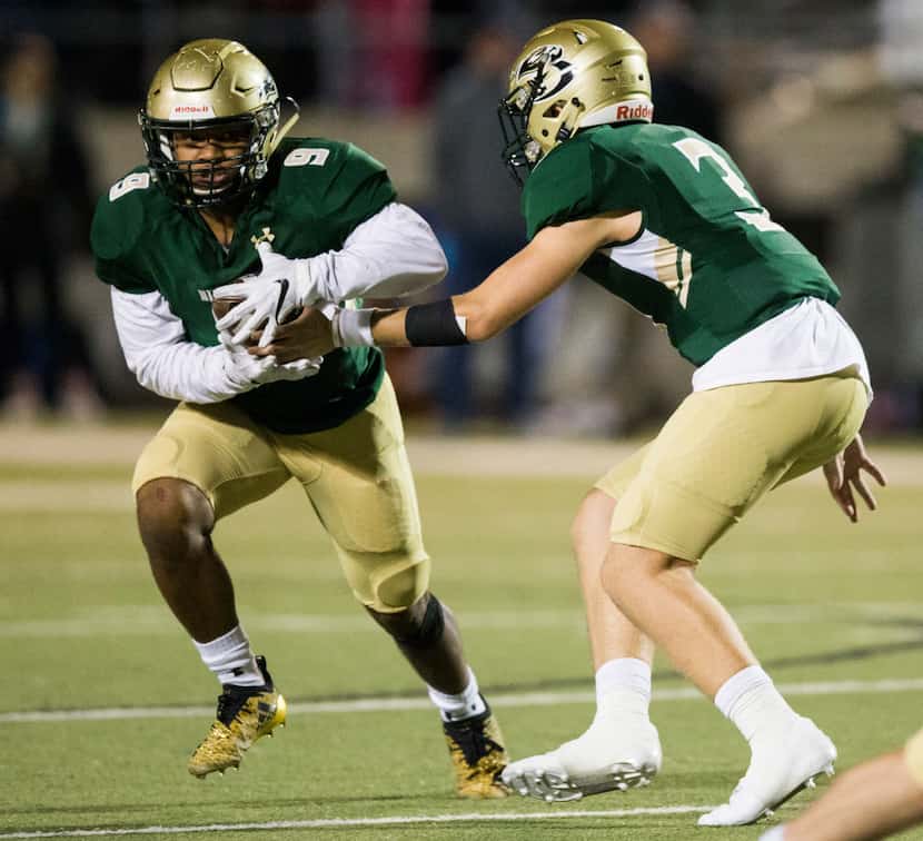 Birdville quarterback Stone Earle (3) hands off the ball to running back Laderrious Mixon...