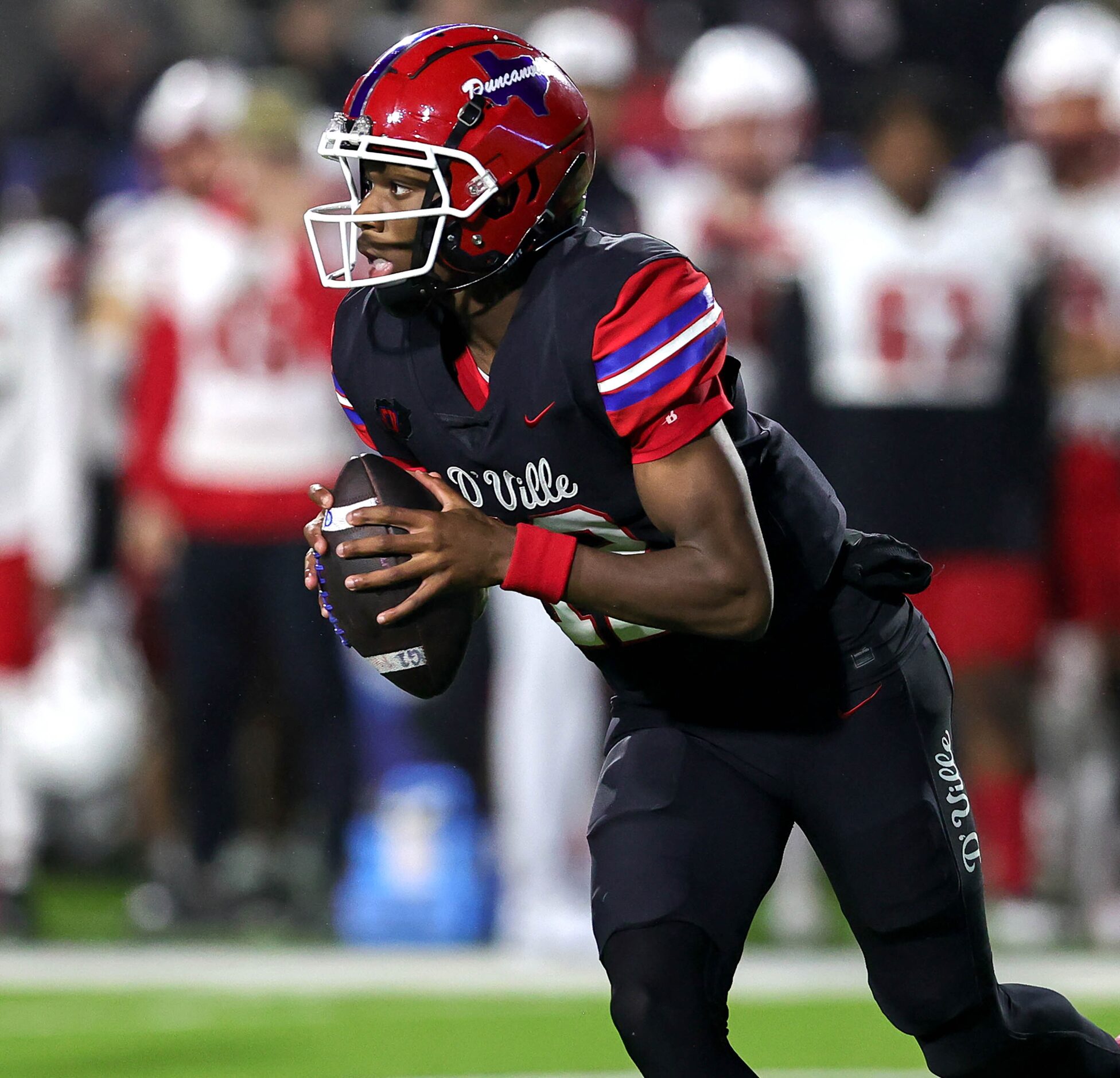 Duncanville quarterback Keelon Russell looks to scramble against Rockwall Heath during the...