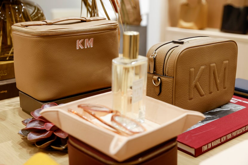 A medium train case (left) and Meadow double zip camera bag sit on a table at Leatherology...