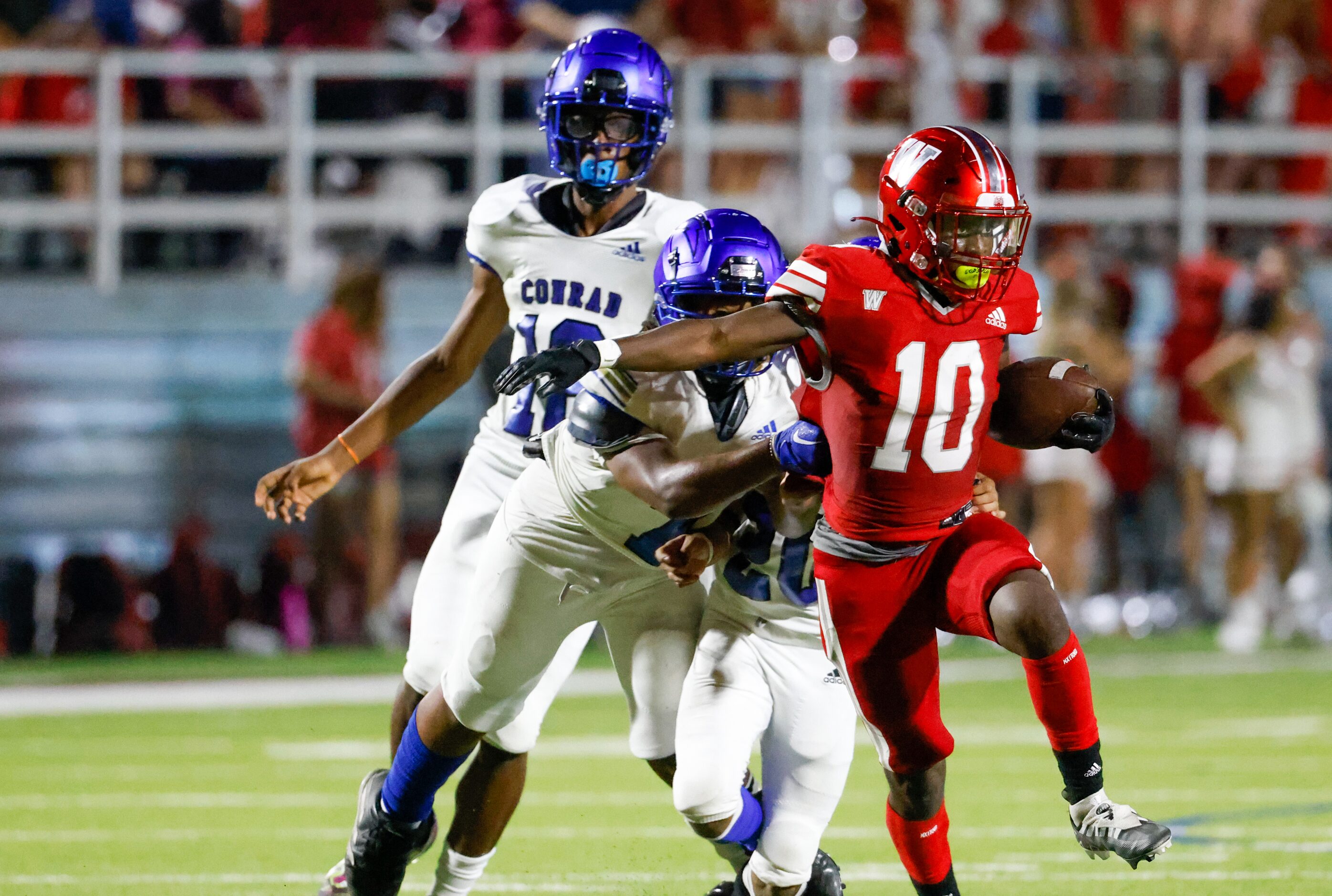 Woodrow Wilson wide receiver Jamel Tony-Black (10) is pulled on by Conrad defense during the...