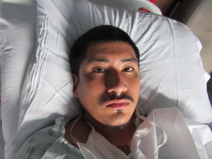 Jose Arroyo, 23, in a booking photo that appears to have been taken from a hospital bed.